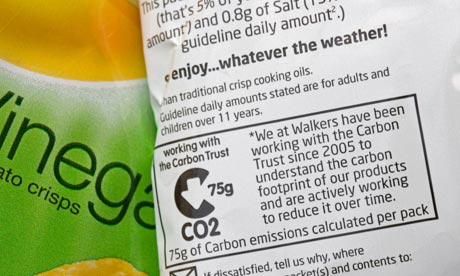 Carbon emissions label showing carbon footprint Walkers salt and vinegar crisp packet UK