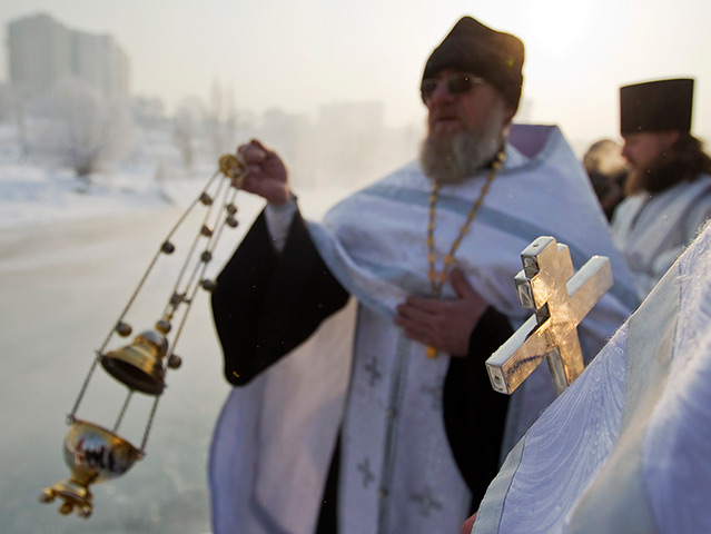 Orthodox Epiphany: Orthodox priests conduct a service on the Bolshaya Almatinka river 