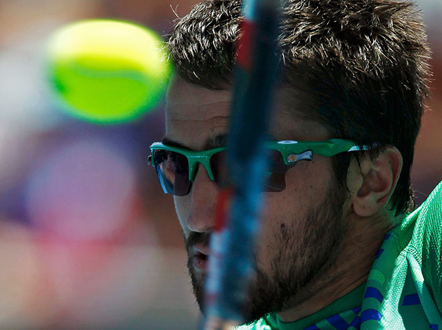Australian Open Day 4: Janko Tipsarevic of Serbia hits a return to James Duckworth