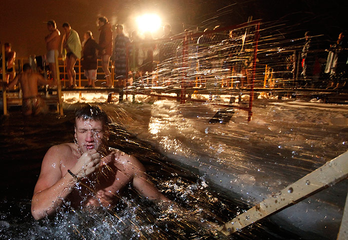 Epiphany Update: A Russian man emerges from the icy water on Epiphany at a pond in Moscow