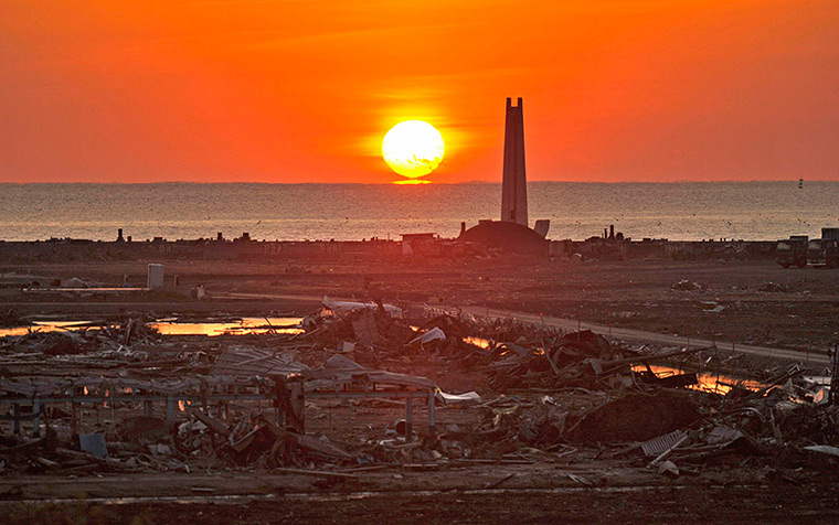 24 hours: Kesennuma, Japan: The sun rise lights up an area devastated by the tsunami 