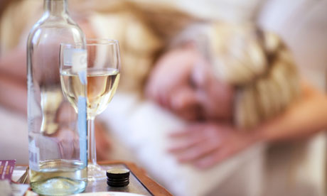 Young woman asleep on sofa after drinking