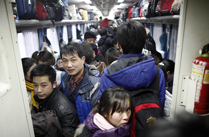China Spring Festival: Passengers board a train at Shanghai's railway station