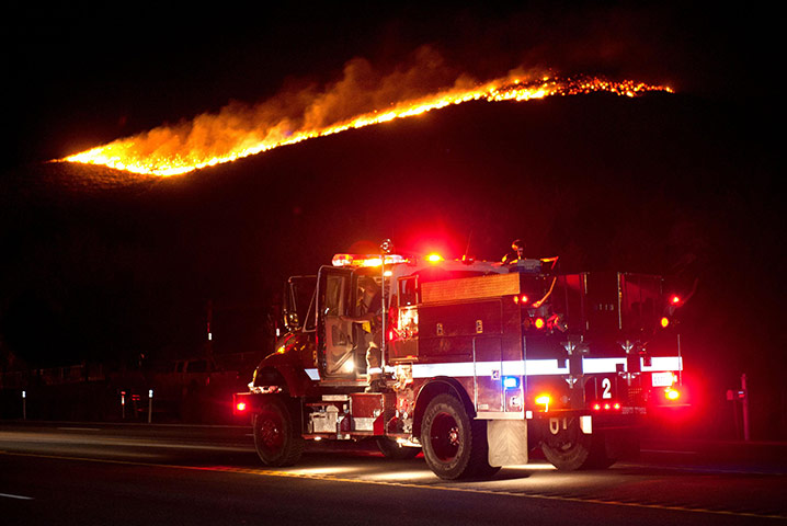 Nevada wildfires: Firefighters wait as the Washoe Drive Fire makes its way down a hill