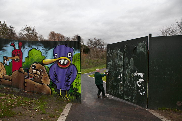 Peace Wall: A Park employee closing the peace wall at 3pm in Belfast