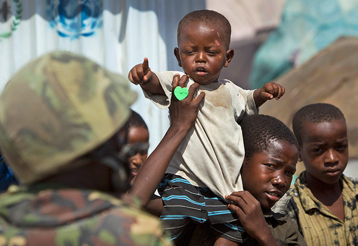 Somalia: A Somali boy and a soldier from the African Union peacekeeping force