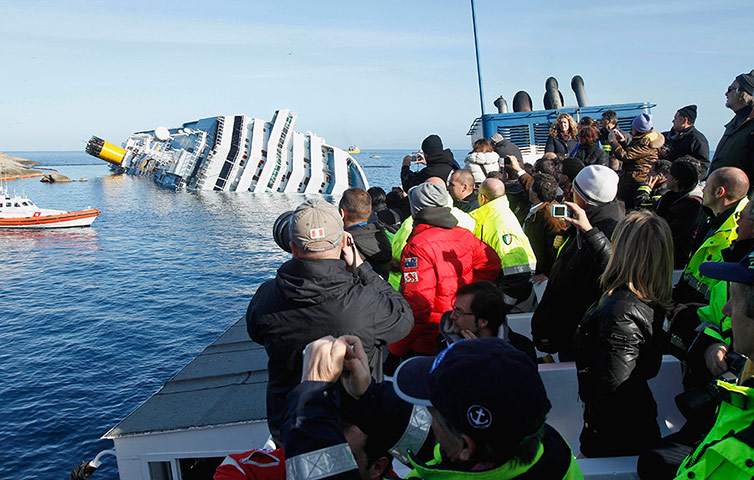 Concordia: People take pictures of the grounded cruise ship Costa Concordia