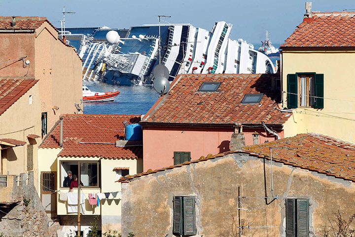 Concordia: The grounded cruise ship Costa Concordia is seen in background
