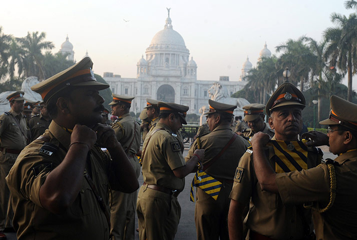 24 hours : Kolkata, India: Indian police officials adjust their uniforms