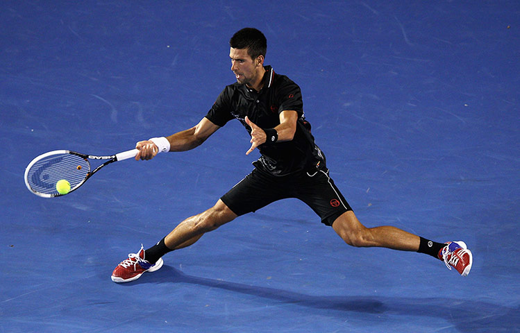 Australian Open Day 8: Djokovic of Serbia plays a forehand against Lleyton Hewitt of Australia