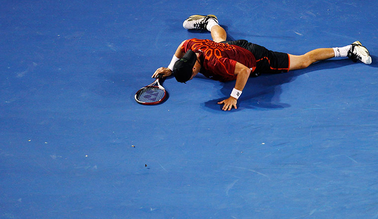 Australian Open Day 8: Hewitt of Australia falls down after returning a shot