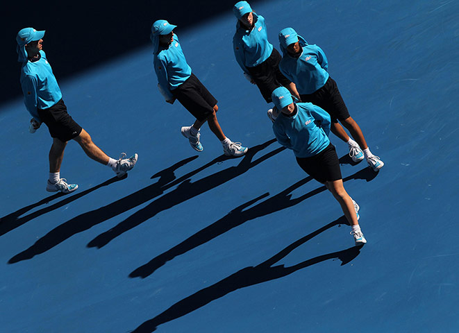 Australian Open Day 8: Court ball boys and their shadows are seen at the Australian Open 