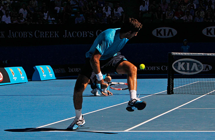 Aussie Open day 9: Del Potro of Argentina plays a shot through his legs