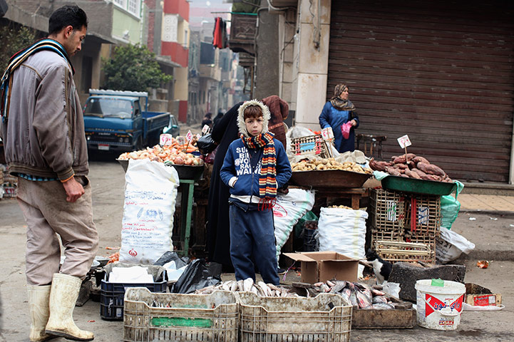 Cairo one year on : A boy stands next to a stall at  Magra El-Oyoun market in Cairo, Egypt