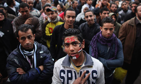 A young man gives the victory sign in Tahir Square, Cairo