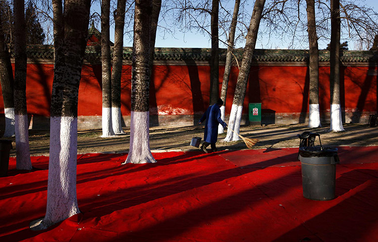 24 hours in pictures: A cleaner sweeps before crowds arrive for the temple fair, Beijing