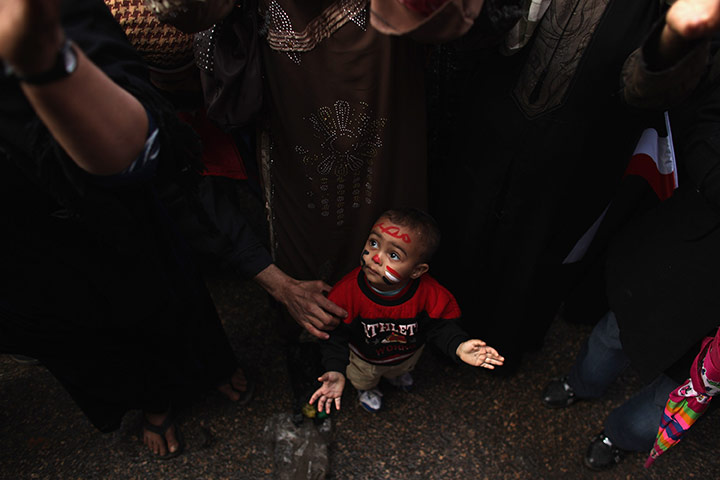 24 hours in pictures: A child in Tahrir Square to mark the one year anniversary of the revolution