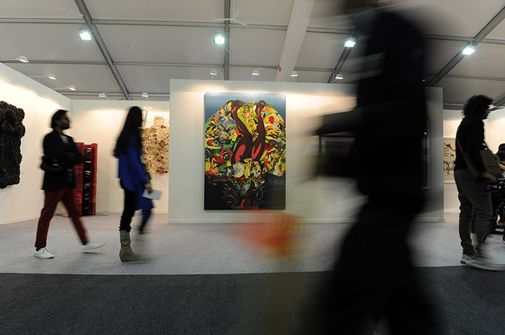 India art fair: Visitors walk past works of art