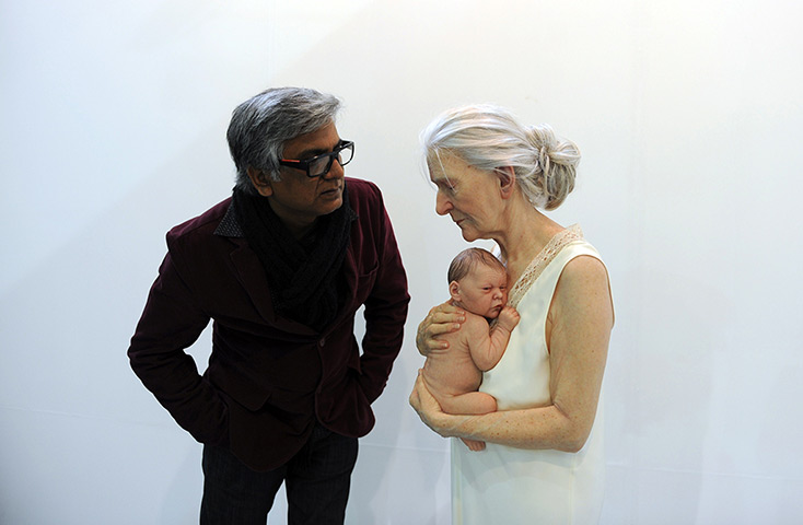 India art fair: A visitor, left, takes a close look at a sculpture by artist Sam Jinks