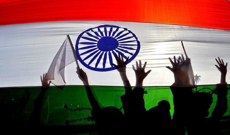 India Republic Day: School children are silhouetted behind an Indian national flag in Bangalore