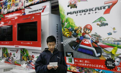Man plays with Nintendo 3DS console in Japanese shop