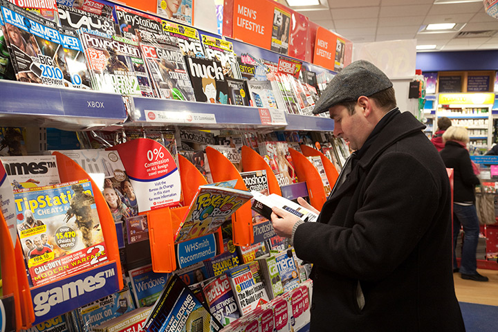 Week in Business: A man looking at magazines in WH Smiths
