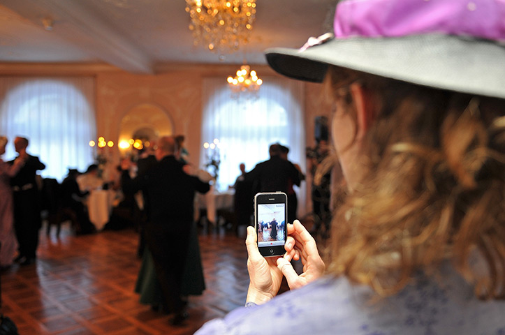Week in Business: A Belle Epoque week enthusiast takes a picture of dancing couples