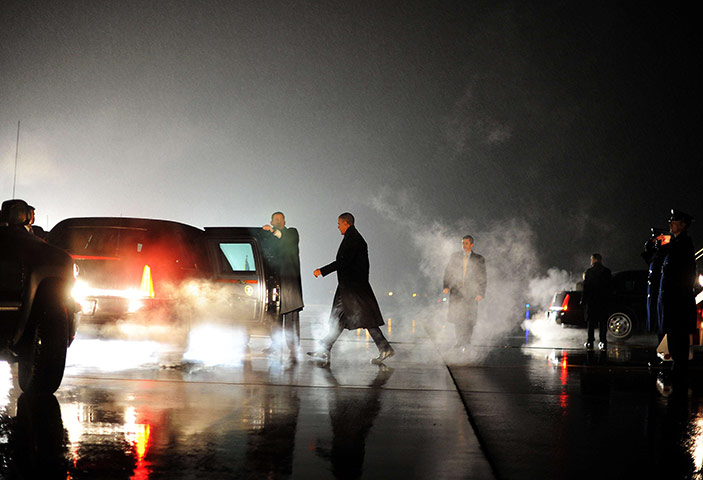 24 hours in pictures: Barack Obama walks to his car upon arriving in Romules, Michigan
