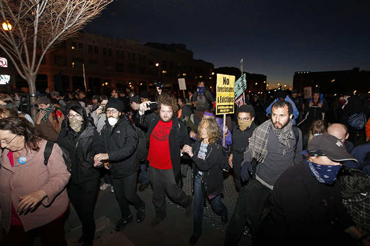 Occupy Oakland: Protestors knock down fences to get away from the police in Oakland