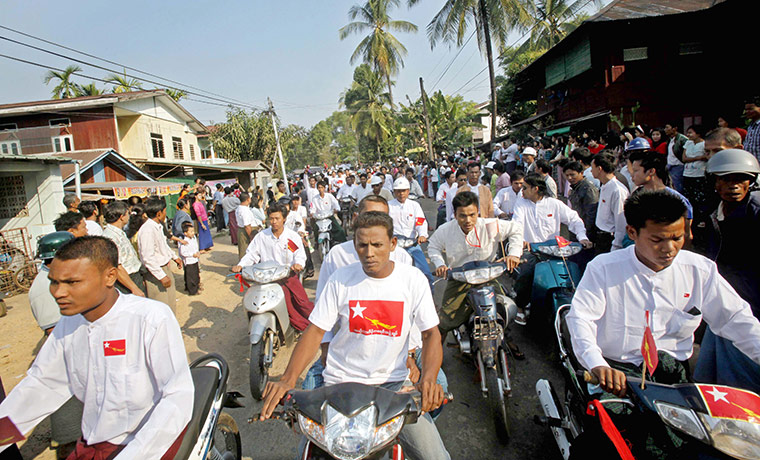 Aung San Suu Kyi campaign: Supporters follow Aung San Suu Kyi on motorbike in Dawei