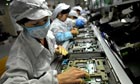 Chinese workers assemble electronic components at Foxconn's factory in Shenzhen