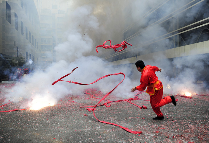 24 hours in pictures: Businesses Set Off Fireworks In Search Of New Year Fortune
