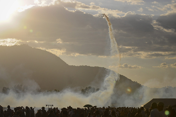 24 hours in pictures:  A pilot performs his routine during the Ilopango Aerial Show 2012 