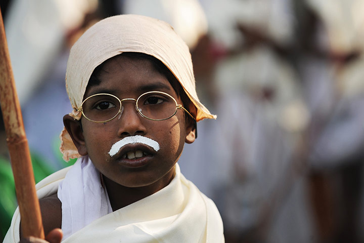 Gandhi world record event: An child dressed as Mahatma Gandhi looks on