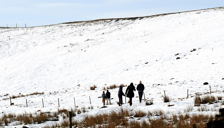 uk winter weather: Walkers in the snow near Pateley Bridge, Yorkshire 