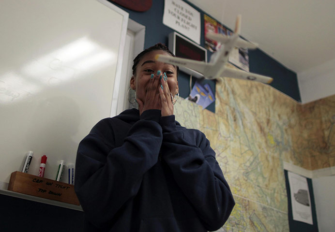 Hope Gardens : A girl watches a model plane during an aviation class 