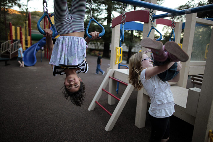 Hope Gardens : Lindzy Earp, left, plays in the playground at Hope Gardens Family Center