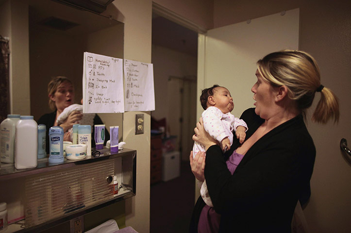 Hope Gardens : Doreen Earp holds her daughter Emily in their apartment 