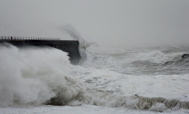 stormy weather in uk: Waves crash over the harbour wall in Dover