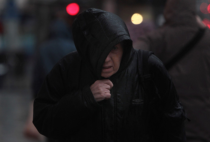 stormy weather in uk: A shopper walks in the rain in Bristol 