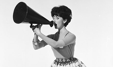 A sixties fashion model holding a megaphone