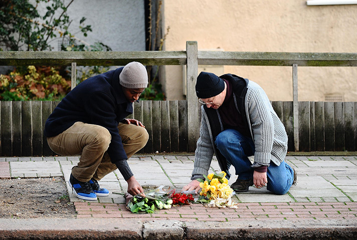 Stephen Lawrence murder : Members of the public lay flowers at the memorial stone of Stephen Lawrence