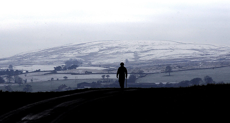 UK weather: A lone walker on the Pennine hilltops in Coverdale