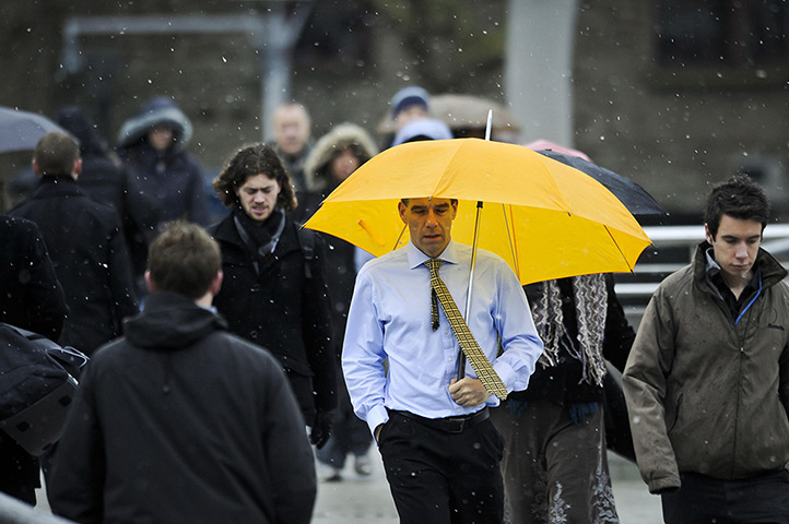 UK weather: Commuters make their way to work in Bristol as snow starts to fall