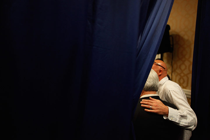 24 hours in pictures: Newt Gingrich poses for photographs during a campaign rally in Florida 