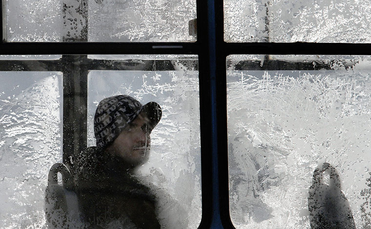 World weather: A man looks from behind a frosty window on a tram in Sofia