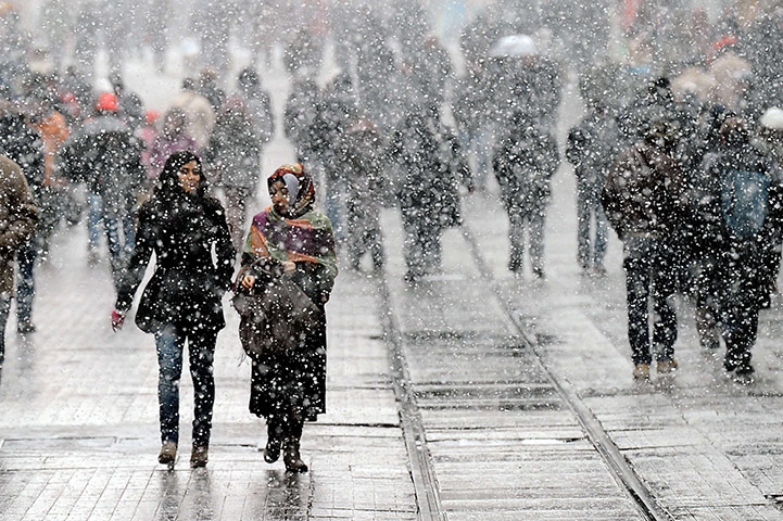 World weather: People walk under snowfall on Istanbul's Istiklal Avenue, Turkey