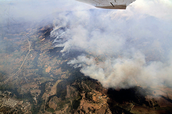 Chile forest fire: Aerial view of smoke billowing a forest fire affecting Quillon, Chile