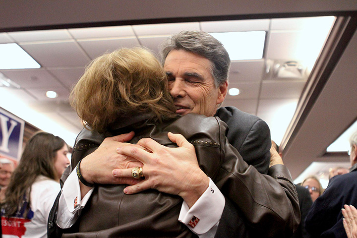 24 hours in pictures: Rick Perry hugs supporters on the day of the Iowa caucus