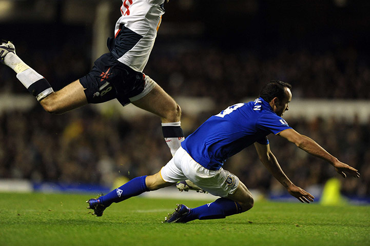 Wednesday Footie: Everton's Landon Donovan is challenged by Bolton Wanderers' Sam Ricketts
